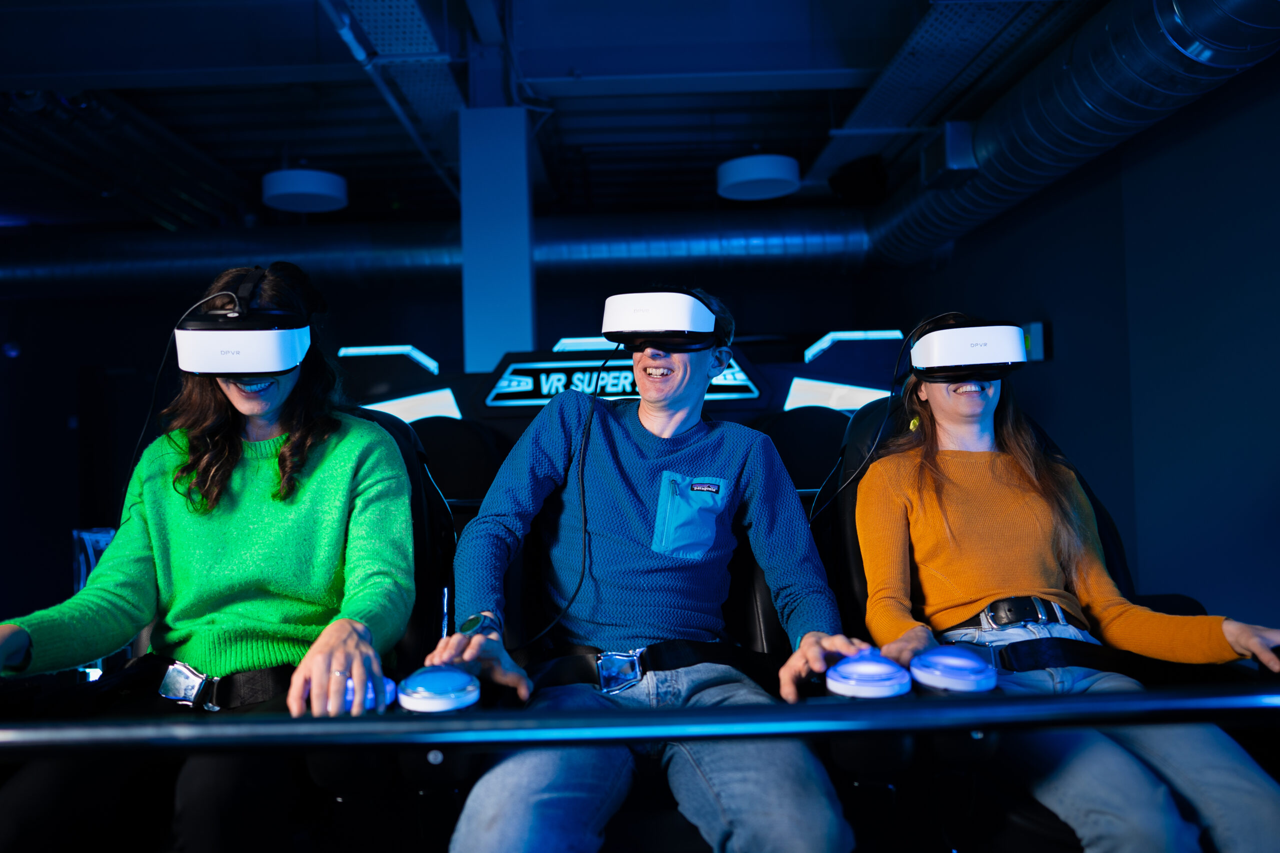 Group enjoying virtual reality experience with VR headsets in an indoor arcade setting.