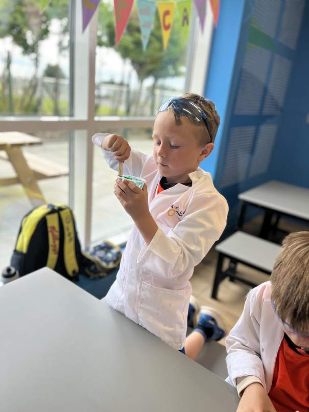 Children creating colorful slime and conducting science experiments at Junior Science Summer Camp