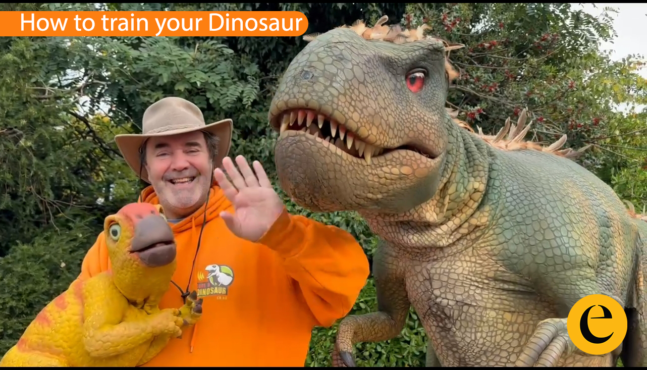 Primal Ranch Augmented Reality Experience - Two dinosaurs facing each other with glowing blue accents against a dramatic red sky