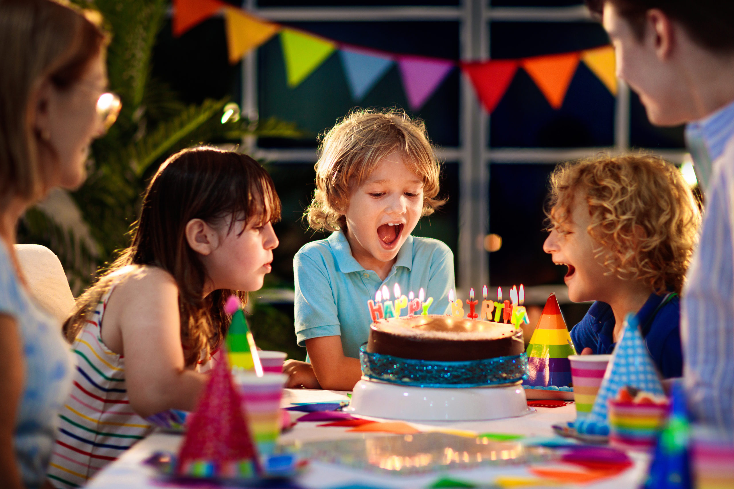 Kids,Birthday,Party.,Child,Blowing,Candles,On,Cake,And,Opening